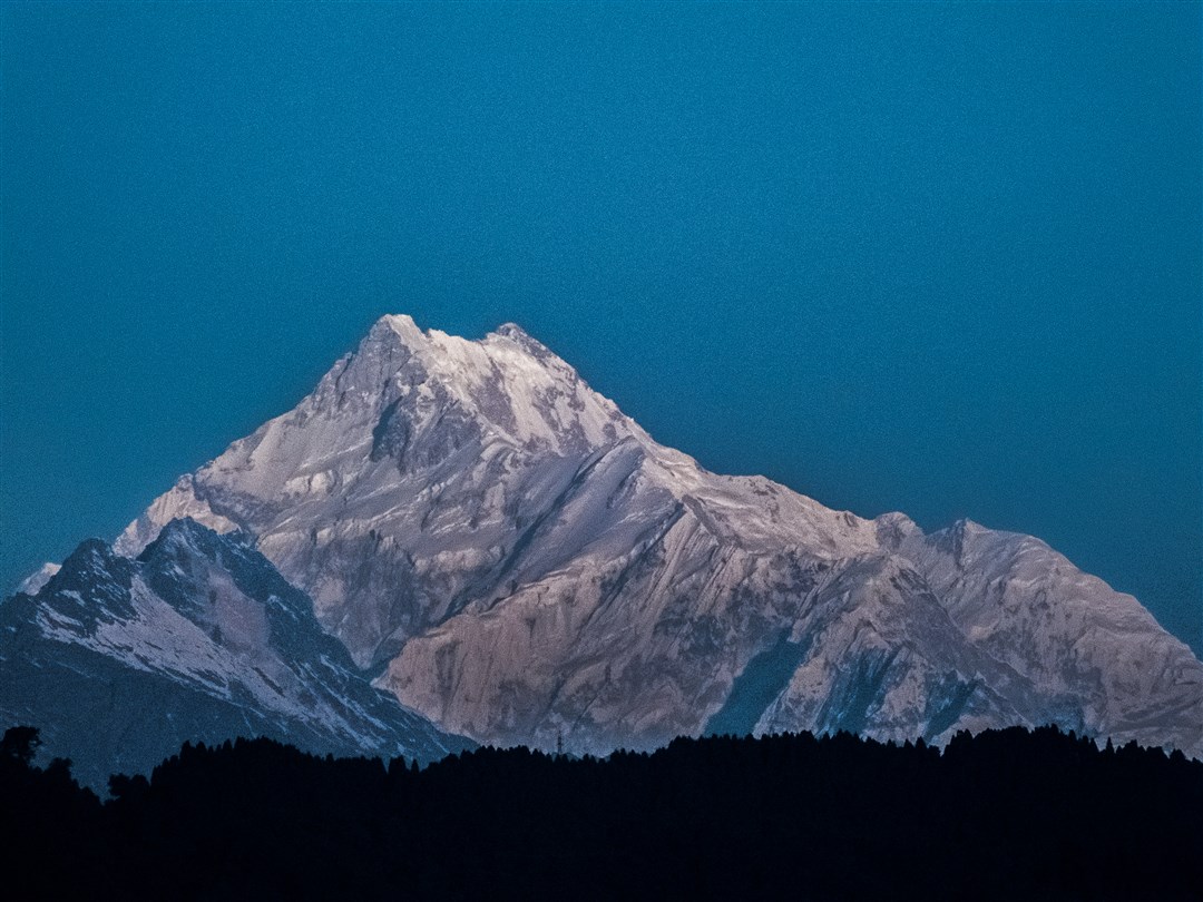 Mount Kanchenjunga in the background and the hills of Gangtok in foreground. Look how tiny the pylon on the hills looks (lower centre) as compared to the mountain.